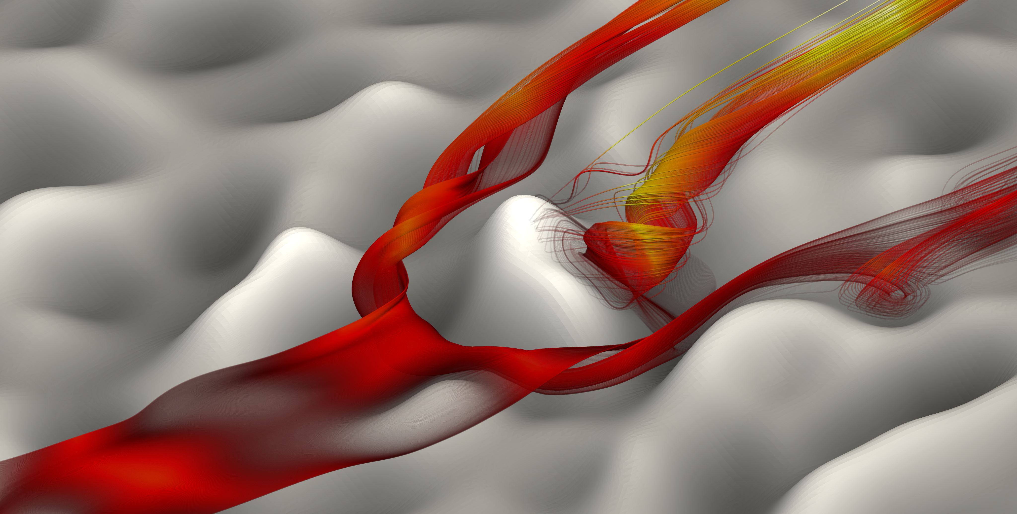 The image was obtained from a DNS of the flow over a rough surface (Reτ=395) and illustrates the complexity of the mean flow within the roughness sublayer. The streamlines were seeded upstream of a characteristic feature of the surface, some of them becoming trapped downstream of that feature before being ejected.
