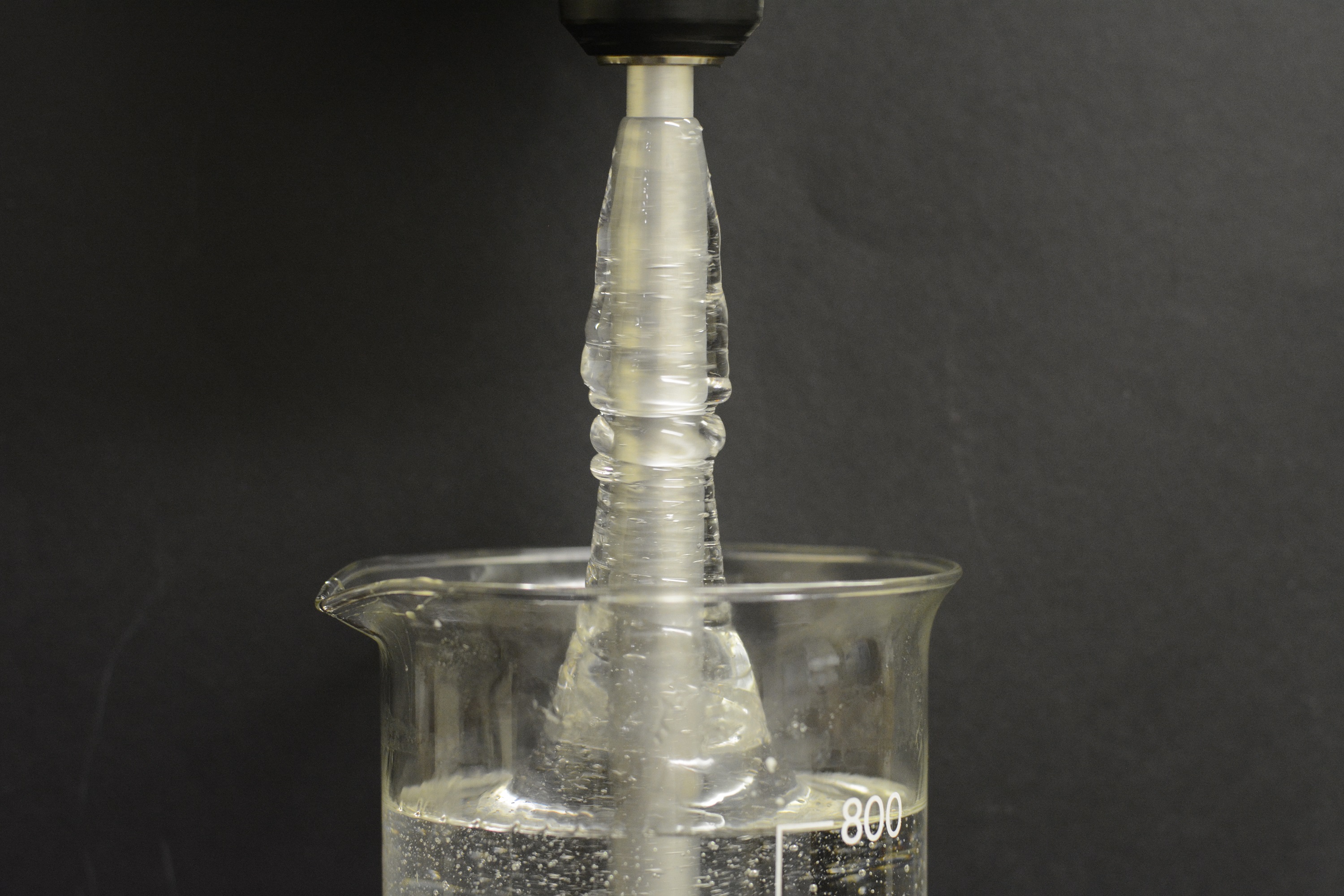 A rotating rod is partially submerged in an aqueous solution (~1wt%) of polyacrylamide acid (PAA).  With inertia present, a Newtonian fluid moves outwards toward the container walls.  Here, however, the fluid climbs the rod due to the elastic stresses generated along the streamlines by the rotation of the rod. The photo is not a composite and has not been enhanced.

