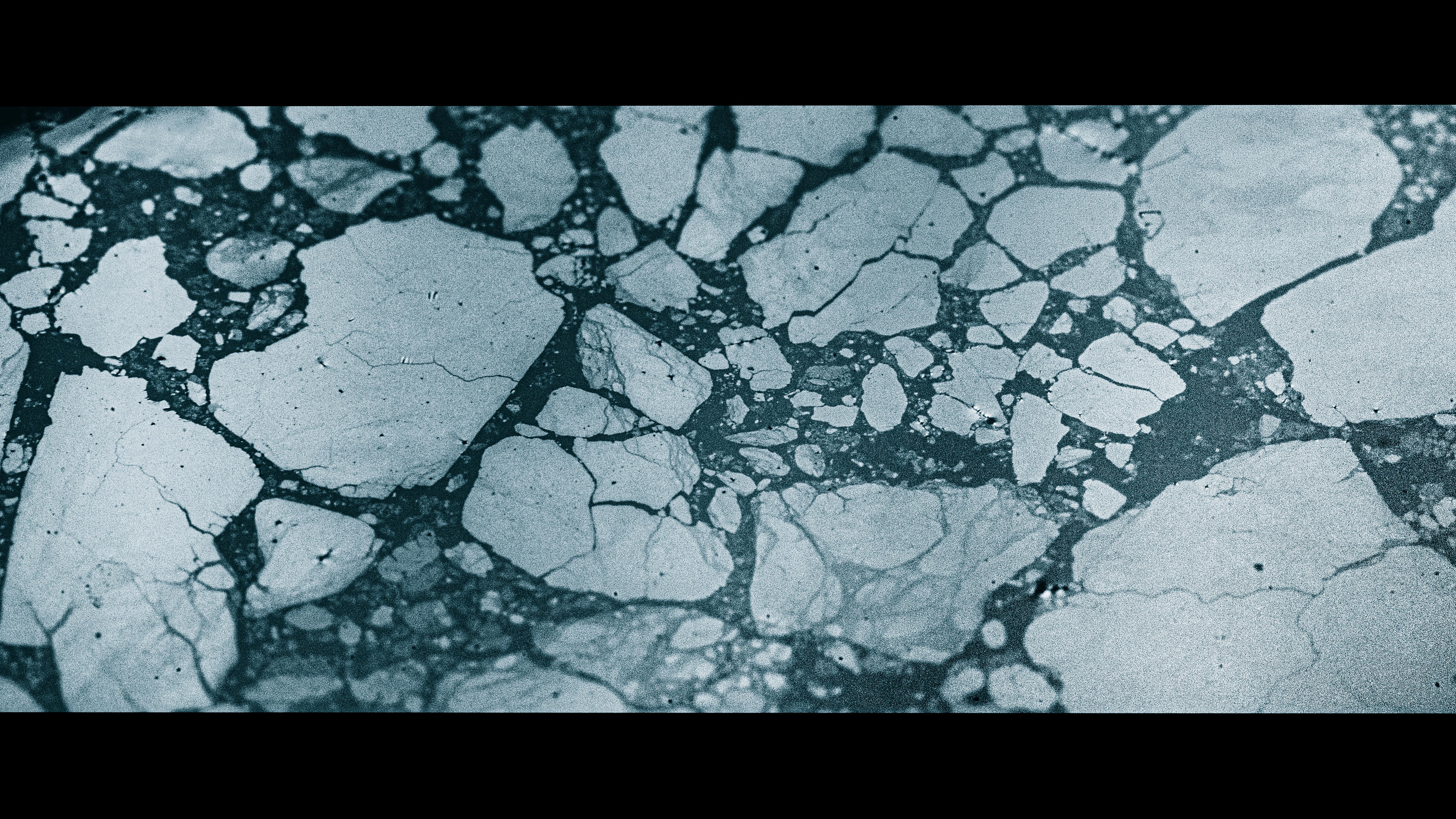 The thin film which forms on the surface of a cup of Earl Grey tea breaks up in a similar fashion to icebergs in the sea. The thin-film pattern formation follows a Cahn-Hilliard-like coarsening process until the breaking up process is complete. This image was taken in the middle of the coarsening process, only colour has been adjusted for creative effect to mimic an actual iceberg.
