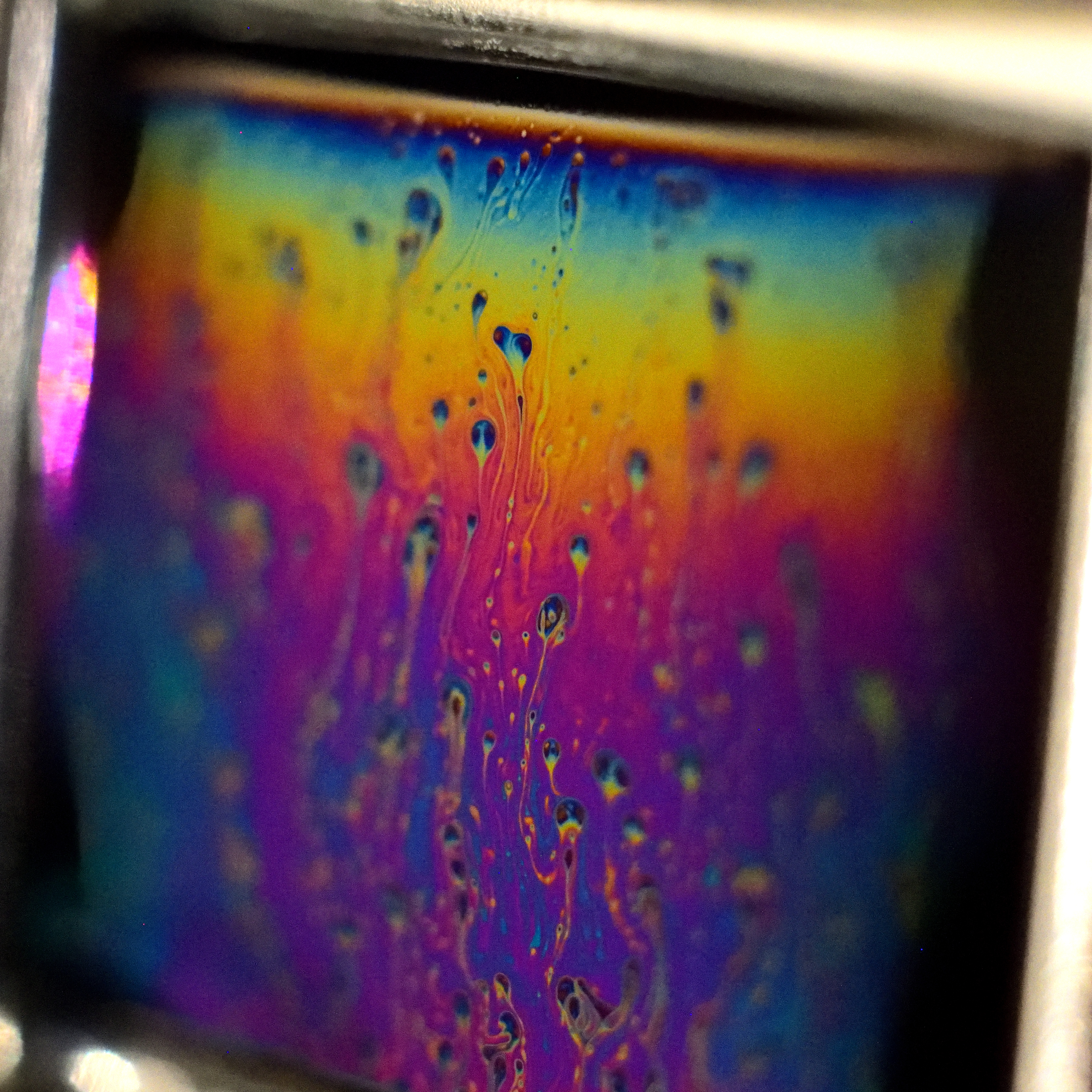 Turbulent flow within the draining of a thin soap film. Colours arise from interference within the thin film indicating differences in thickness.
